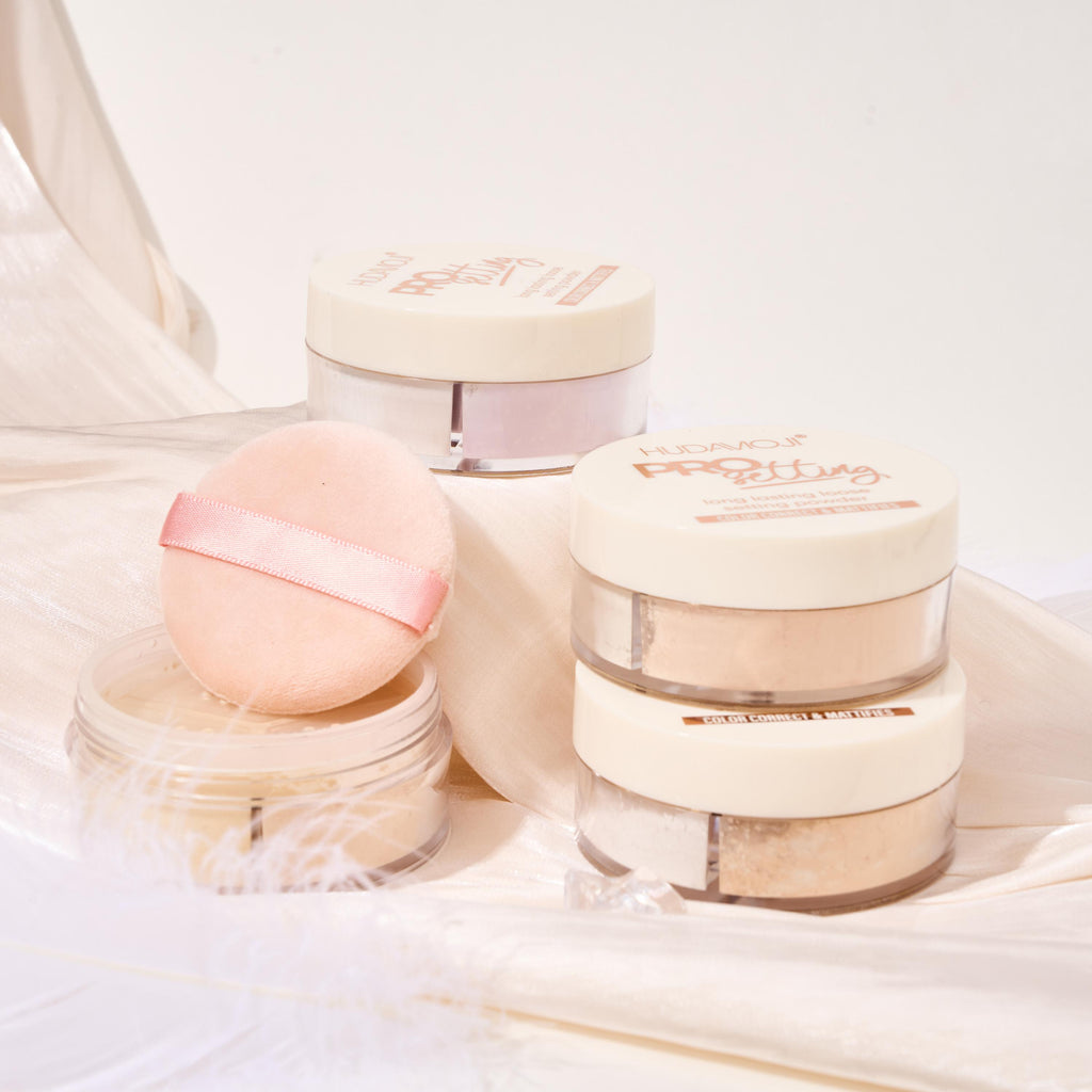 Cosmetic products including jars and a pink ball on a light background