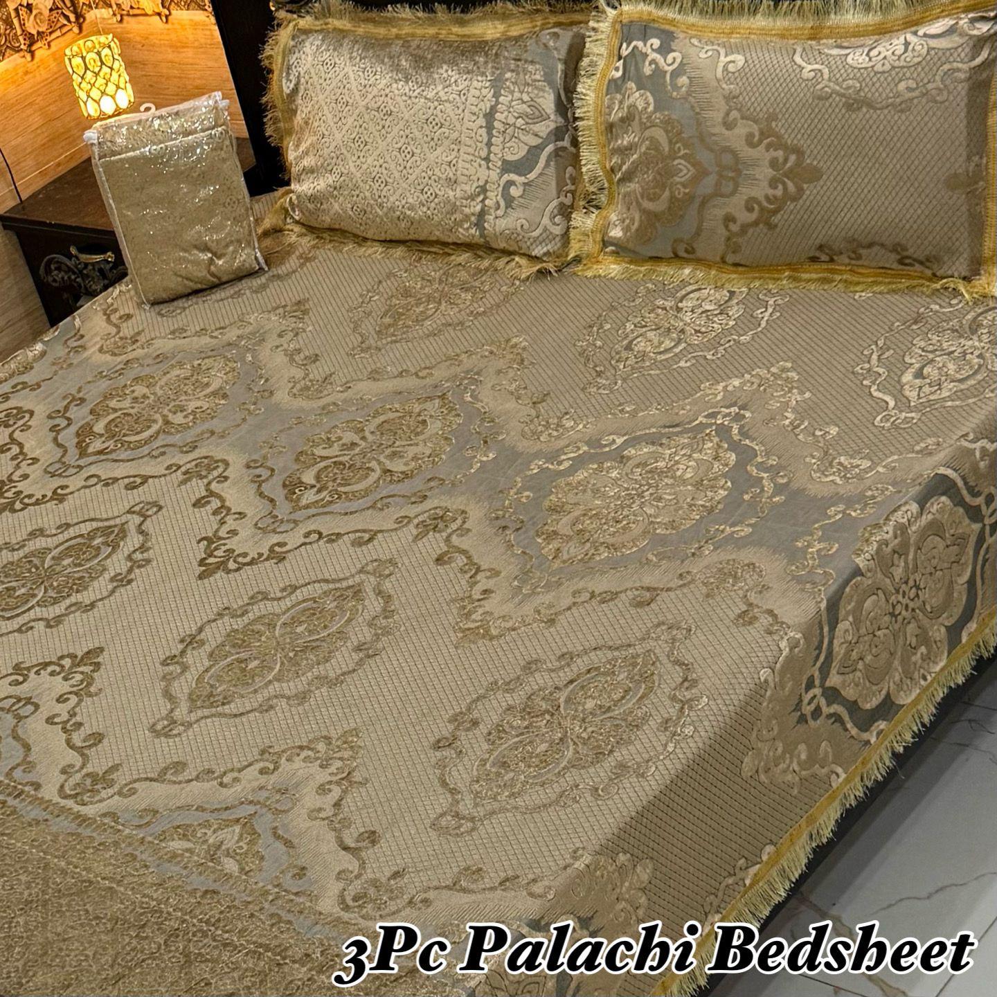 Decorative bedspread with intricate patterns on a bed, labeled '3Pc Palachi Bedsheet'.