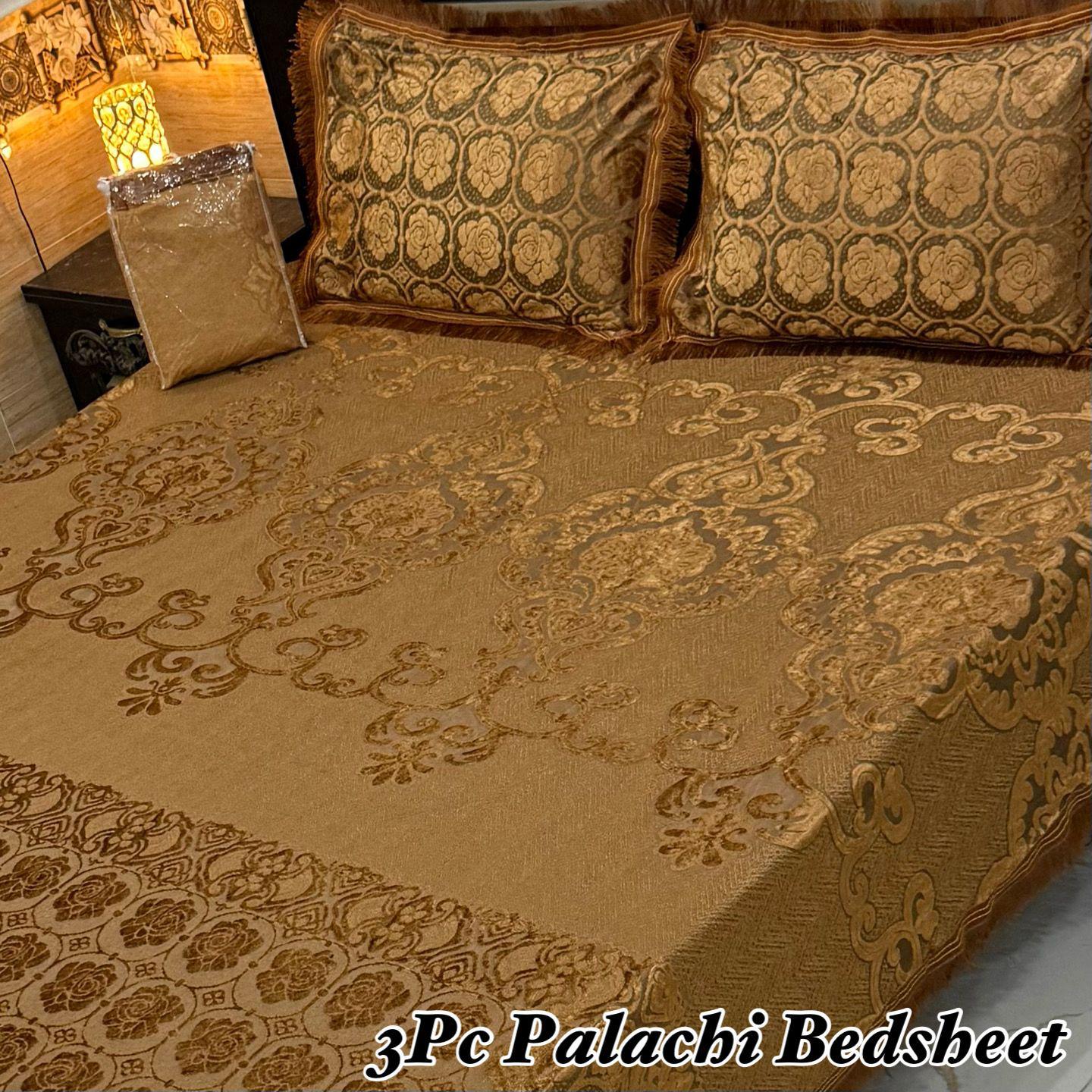 Decorative brown bedspread with intricate patterns on a bed, featuring '3Pc Palachi Bedsheet' text.