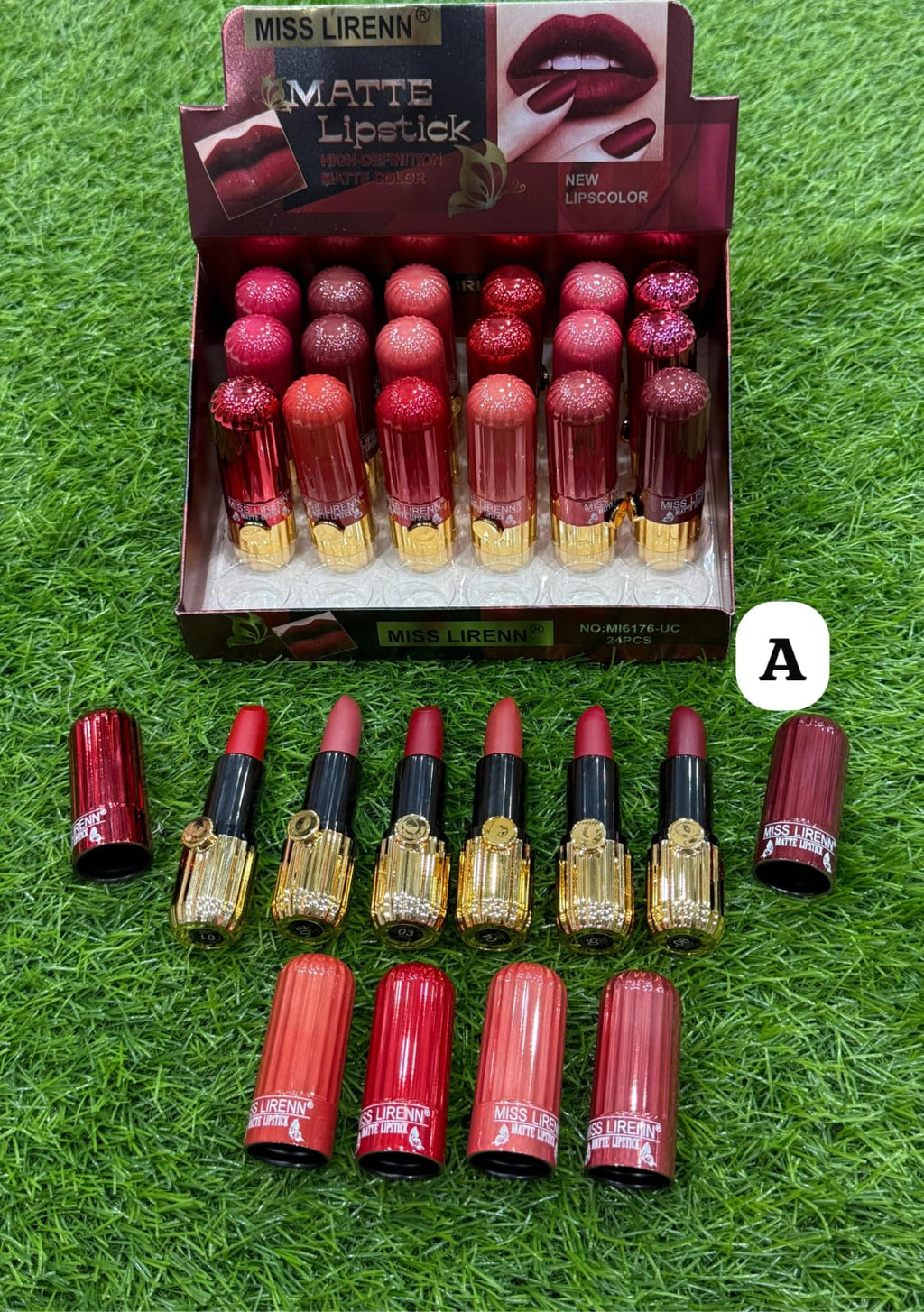 Display of Miss Liren matte lipsticks with a box on a grass-like background