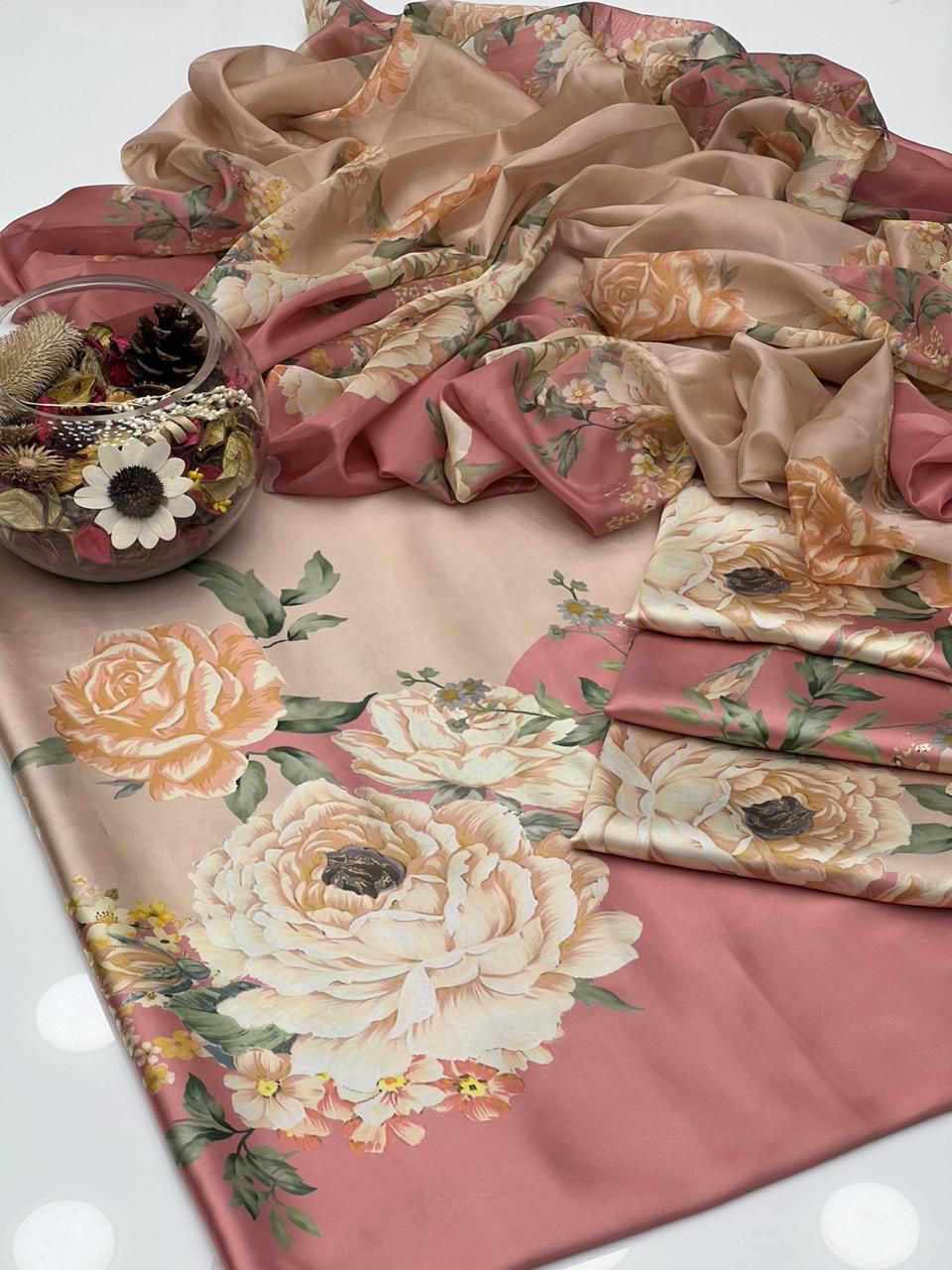 Floral patterned fabric with a pink and beige color scheme on a white background