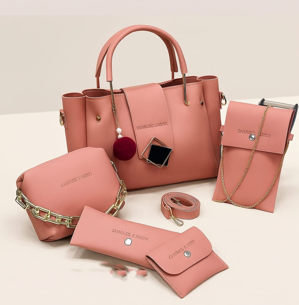 Set of pink handbags and accessories on a light background